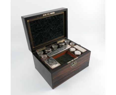 A 19th century coromandel wood travelling box, with plated mounted bottles and fitted with a drawer below, width 12ins   Cond