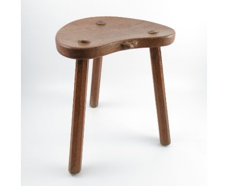 An oak cricket stool, by Robert Mouseman Thompson, with kidney shaped seat, raised on three chamfered legs