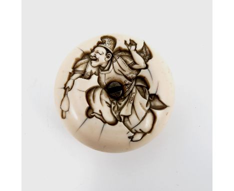 A 19th century Japanese carved ivory manju netsuke, of squashed circular form, the one side deeply carved with a figure danci