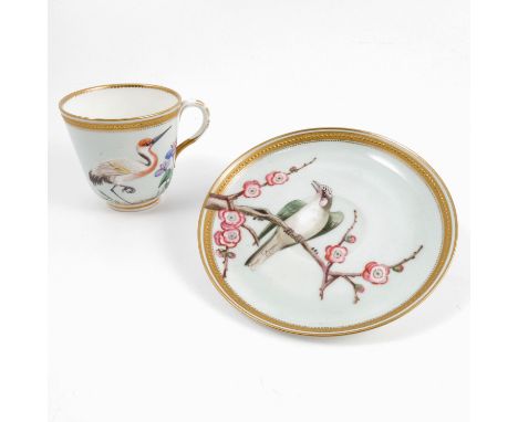 A 19th century Royal Worcester cup and saucer, decorated with birds and flowering branches to a pale blue ground, with gilt e