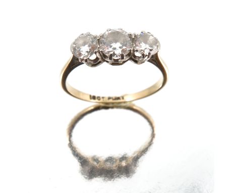 A three stone diamond ring, stamped '18ct' and 'Plat', the graduated brilliant cuts totalling approximately 1 carat, finger s