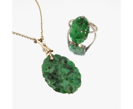 A carved jade pendant, with a pearl set divider, on a chain, and a jade set panel ring