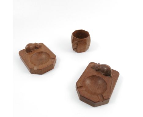 An oak napkin ring, together with two ashtrays, all by Robert Mouseman Thompson