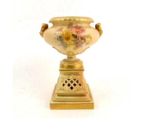 A Royal Worcester blush ivory vase, the urn top mounted on a pierced pedestal, decorated with floral sprays, shape number 194