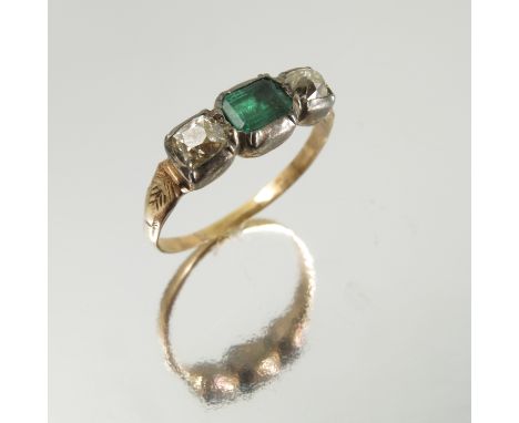 An emerald and diamond three stone ring, circa 1800, the silver collet closed back set stones to an unmarked shank, the old m