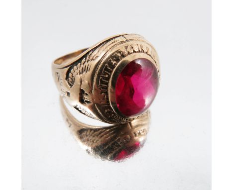 An American synthetic ruby graduation ring, stamped '10k' and 'Balfour', finger size T, 14.2g gross