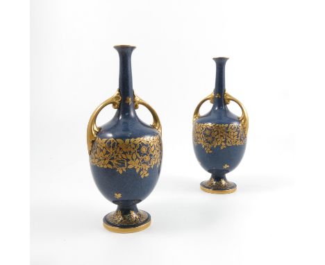 A pair of Royal Worcester vases, with a pair of gilt handles, the mottled blue ground decorated with a band of gilt flowers a