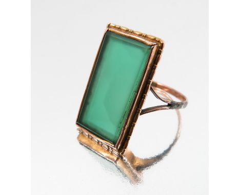A green agate panel ring, unmarked, the panel approximately 1.9cm by 1cm, finger size O, 3.2g gross