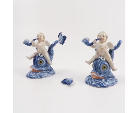 Two Continental porcelain figures, of cherubs blowing horns astride mythical sea creatures, with underglazed blue R to base, 
