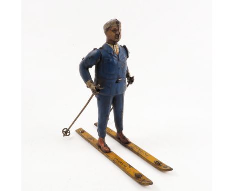 A Lehmann Ski Rolf, clockwork tin plate model of skier, dressed with a blue suit with shirt and tie, holding a pair of poles,