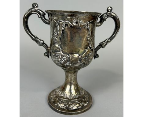 A VICTORIAN SILVER TWIN HANDLED CUP MARKED FOR HENRY HOLLAND DECORATED WITH MUSICAL INSTRUMENTS, 18cm x 16cm Weight: 335gms 