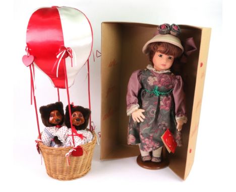 A Lenci doll in purple dress on wooden stand, 46cm, with certificate and original box, a Robert Raikes Hot Air Balloon bears,