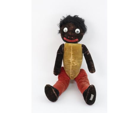 A Golliwogg doll by "Chad Valley", the stitched velveteen and jointed body, flock filled and painted features, 44cms.