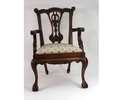 A doll's reproduction Chippendale style foliate carved mahogany elbow chair, similar to lot 379.