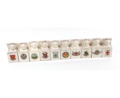 Ten crested china models of Golliwogg jack-in-the-box with crests of Minehead, Newport, Sandringham, Newcastle, York, Coventr