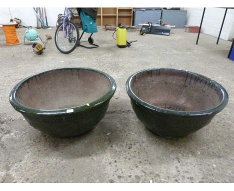 A pair of large dark green glazed ceramic planters