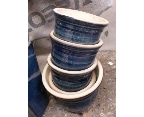 Five circular blue glazed plant pots