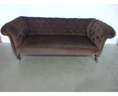 A Victorian button back Chesterfield on turned front legs 