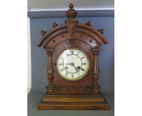 A mahogany mantel clock with eight day Junghams movement, white dial with Roman numeral 