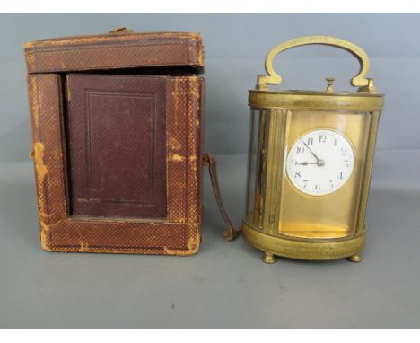 An early 20th century brass cased French oval eight day carriage clock repeater, enamel dial with Arabic numerals chiming on 