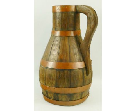 A late 19th/early 20th century coopered oak jug, of pear-shaped form with ring handle, the top copper band inscribed V. Radfo