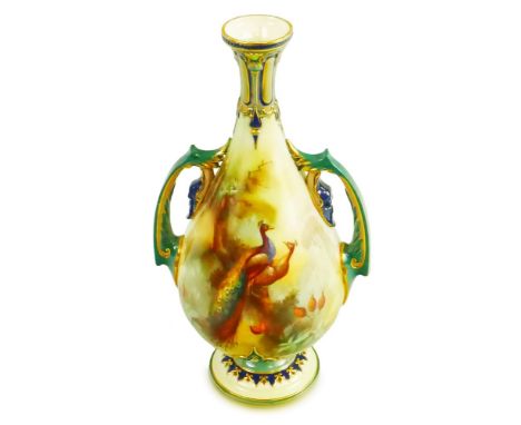 A Royal Worcester vase, of two-handled pedestal baluster form, printed and painted with peacocks perched in a pine tree, the 
