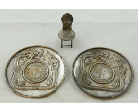 A Chinese silver coin dish, apparently unmarked, inset with a 1911 one dollar coin, the border with an embossed and chased dr