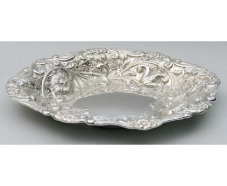 A Victorian silver dish, by Gibson & Langman, London 1892, of oval shaped form with embossed and chased floral decoration, 27