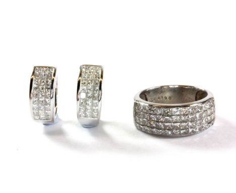 An 18ct white gold ring lavishly set with princess cut diamonds with a matching pair of 18ct white gold earrings. (All stampe