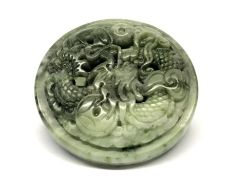 A Chinese carved green jade / hardstone buckle decorated with a dragon, Dia. 5.5cm.