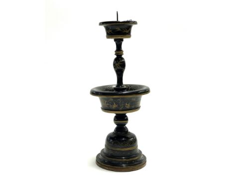 A 19th century Chinese turned wooden and lacquered altar candlestick, H. 30cm.
