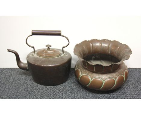 A hammered copper planter and early copper kettle.