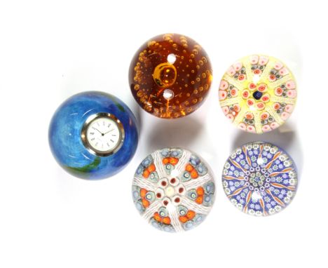 A group of five glass paperweights including a Strathern, a Strathern dated 5/78, a Perthshire pre 1978, a Caithness clock an