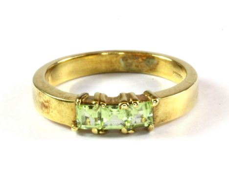 A heavy quality 9ct gold ring set with three peridot. (M) Approx. 3.6 g.