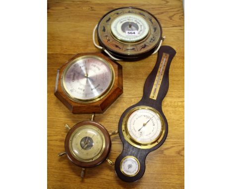 Four vintage barometers.