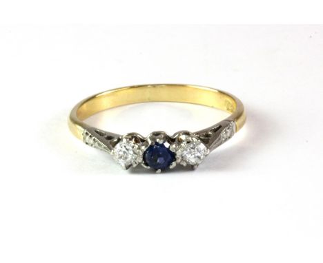 An 18ct gold (stamped 18ct) ring set with a sapphire and two diamonds. (M.5)