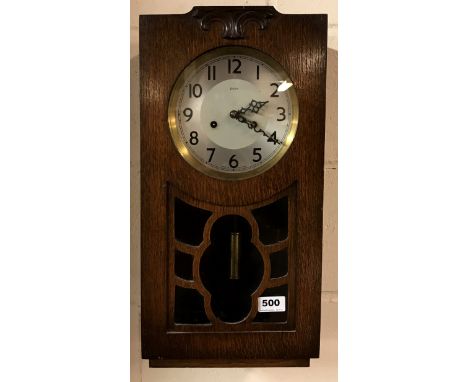 A 1930's Enfield oak wall clock, H. 49cm.