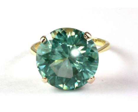An 18ct gold ring set with a large (over 6ct) natural green zircon. (M)