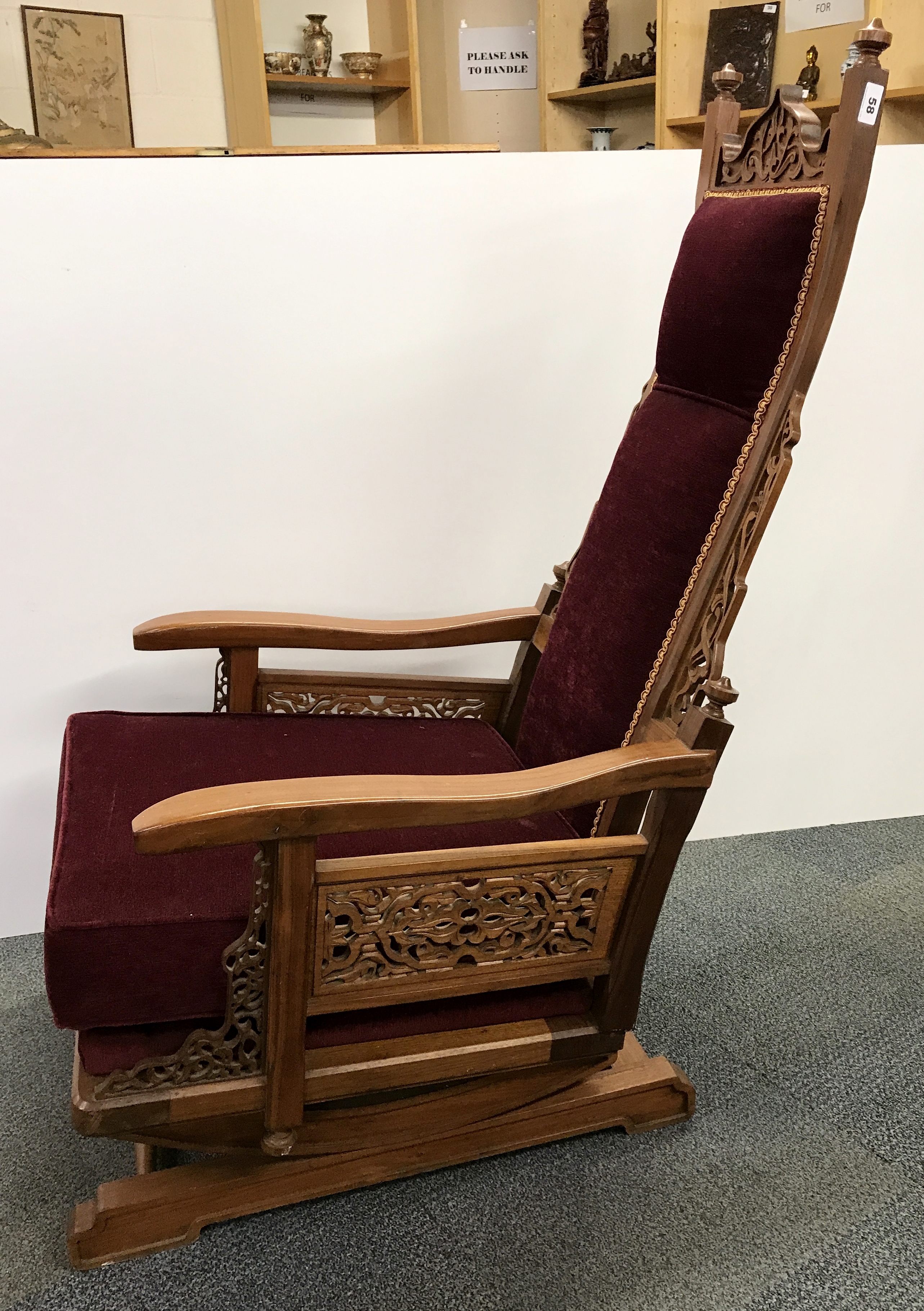 An early 20th century American Colonial carved rocking chair, H. 131cm.
