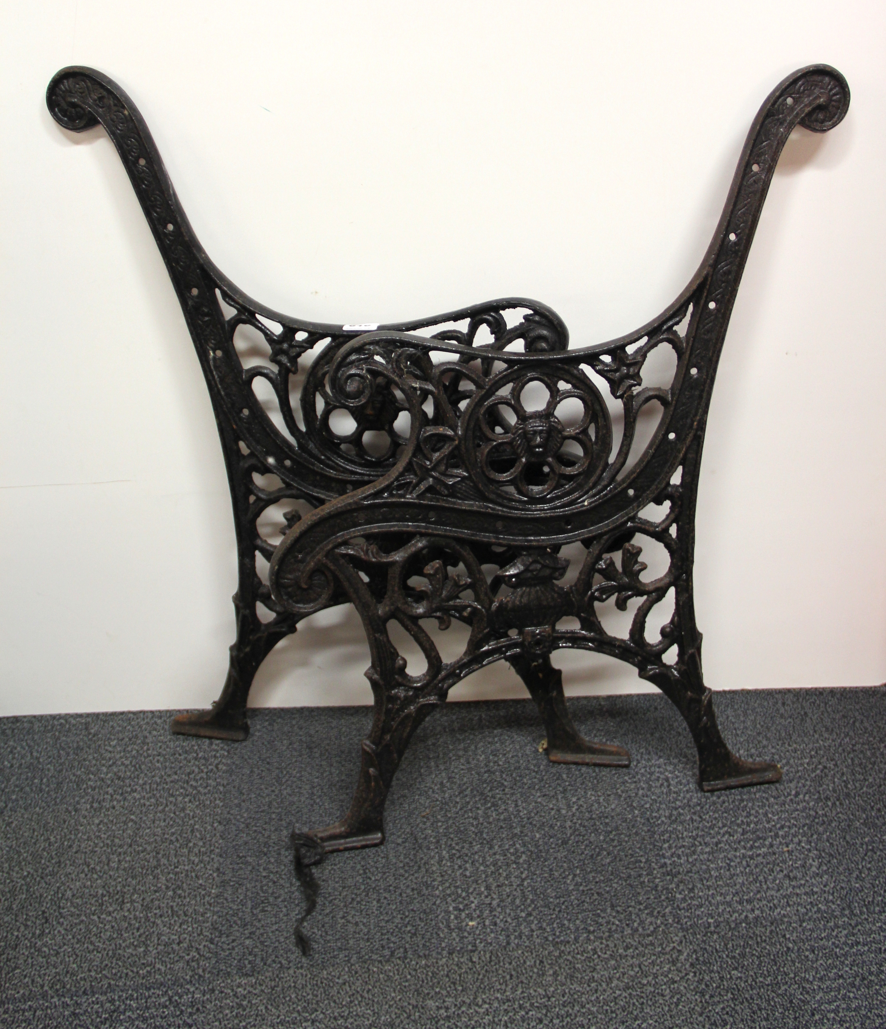 A pair of old cast iron bench ends.