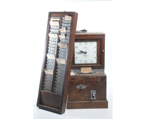 A National Time Recorder Co. Ltd. stained beechwood cased clocking in and out clock
With a 20cm white dial with Arabic numera