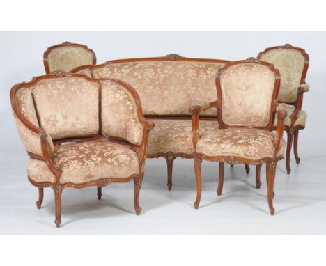 A Continental three piece drawing room suite
Comprising a settee with a shaped back with a leaf and flower cresting with curv