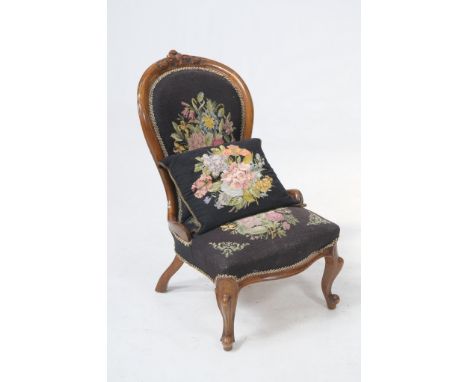 A Victorian spoon back drawing room chair
With a leaf carved cresting floral tapestry back and serpentine seat raised upon fr