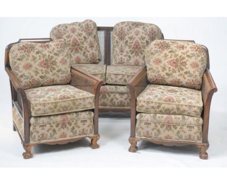 An Early 20th Century walnut and rattan three piece Bergère suite
The two seater settee with a shaped back enclosing two pane