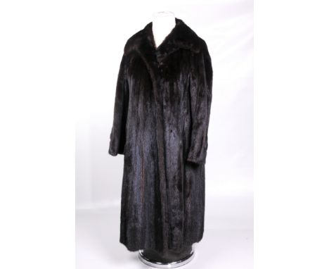A fine quality chocolate mink coat, circa 1970's
Full length of swing form, with flared sleeves with button detailing, decora