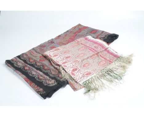 Two good quality early to mid 20th Century Paisley throws
The first on black ground approx 3.06x1.78m, the second on ivory gr