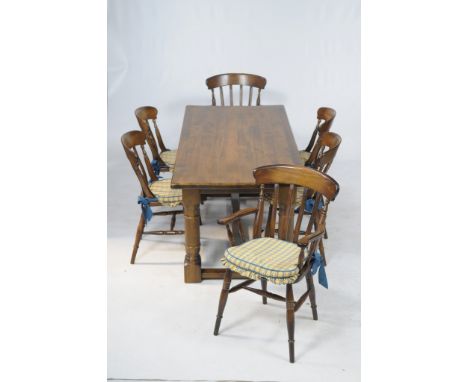 A Reproduction stained beech wood refectory table
With a rectangular top raised on 4 ring turned baluster supports with plain