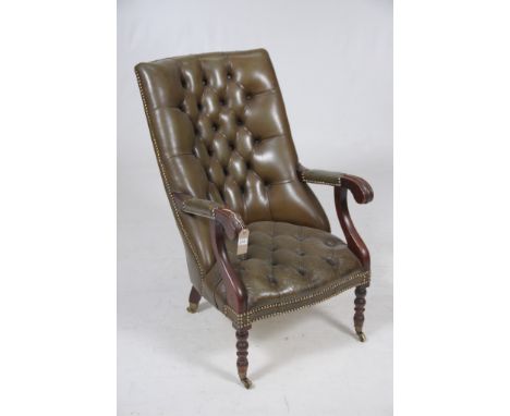 A mahogany and leather button back elbow chair 20th Century
The raked padded button back with padded open arms raised upon fr