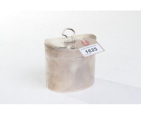 A George V silver tea caddy
Of swept cylindrical form, the hinged cover surmounted by a stylised arch handle, revealing empty