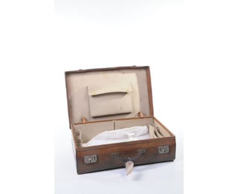A pigskin suitcase by Army & Navy
The lid with black initials JVJ, a lined interior with a hinged compartment, the lower sect